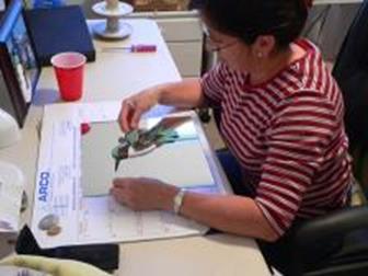 Ana Burrell working on her beautiful mosaic rock art.